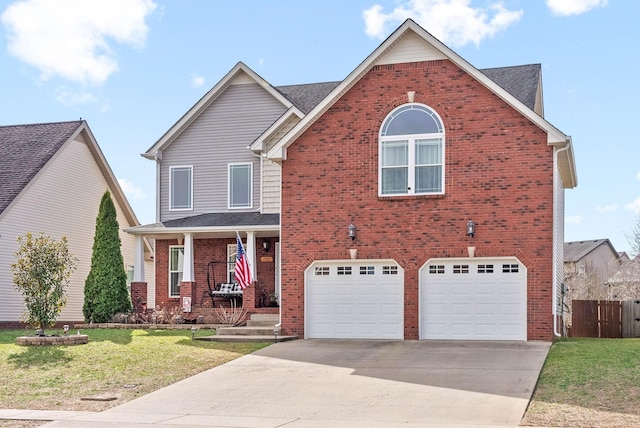 traditional home featuring a front yard, fence, concrete driveway, and brick siding