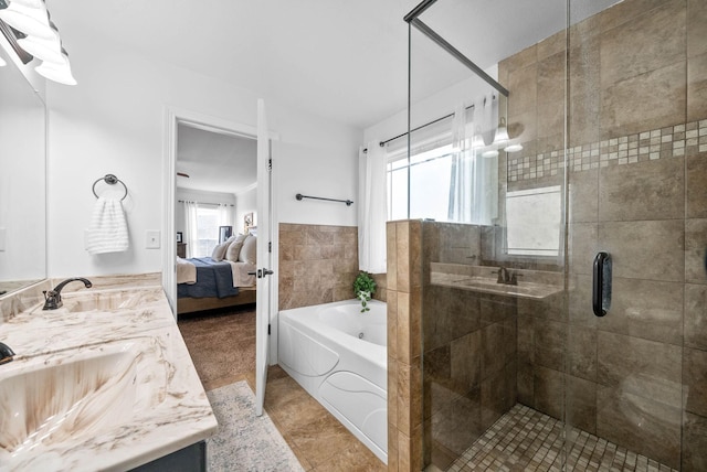 full bath featuring a garden tub, ensuite bath, a wealth of natural light, and a sink