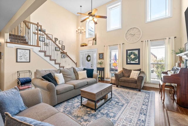 living room featuring hardwood / wood-style floors, stairway, and a ceiling fan