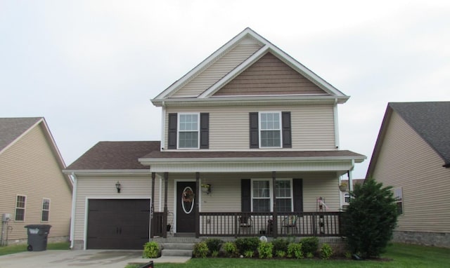 view of front of property featuring covered porch, an attached garage, and concrete driveway