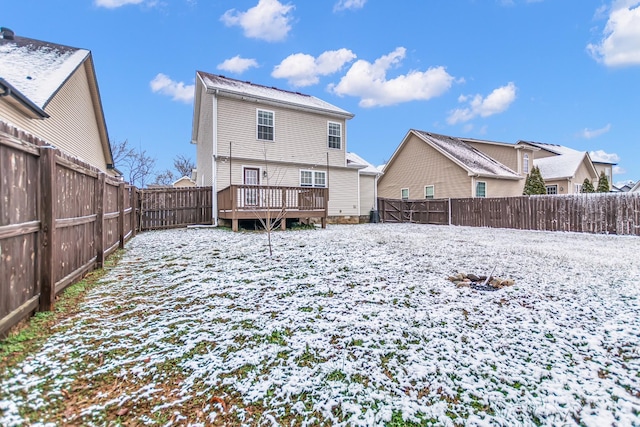 back of property with a fenced backyard and a wooden deck