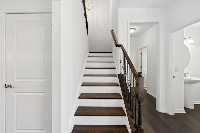 stairs featuring baseboards and wood finished floors