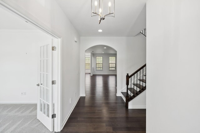 entrance foyer featuring baseboards, arched walkways, wood finished floors, and recessed lighting