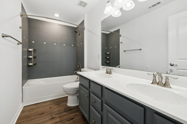 full bath featuring visible vents, a sink, and wood finished floors