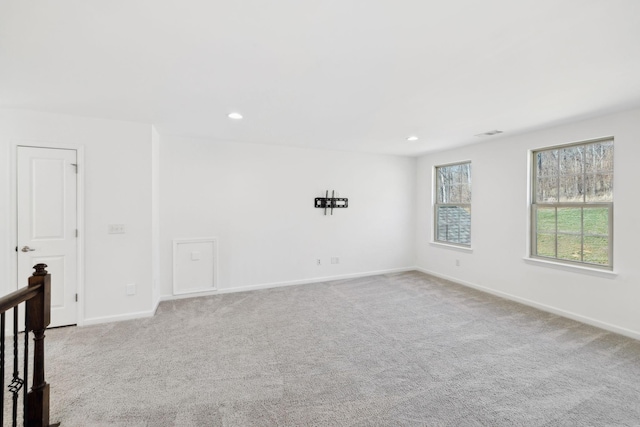 spare room with carpet, baseboards, and recessed lighting