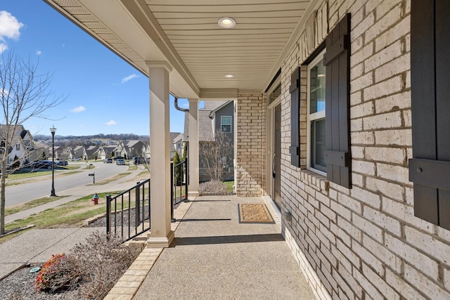 view of patio / terrace with a residential view and covered porch