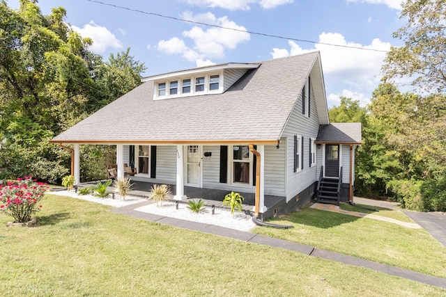 view of front of home featuring a porch, a front yard, and roof with shingles