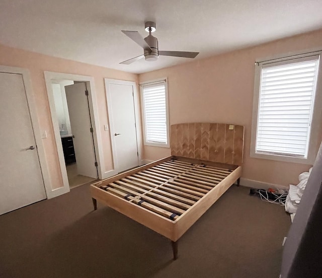 carpeted bedroom with baseboards and ceiling fan