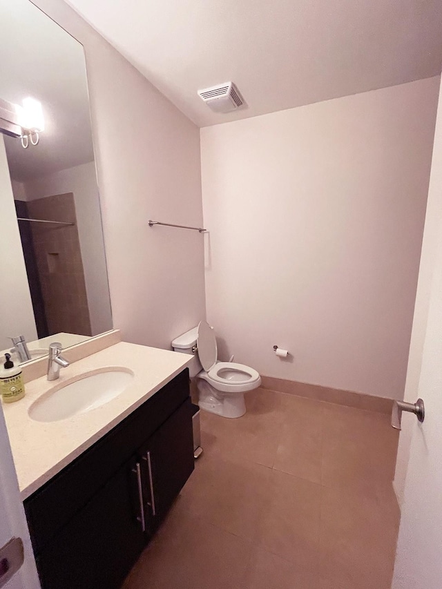 bathroom with visible vents, baseboards, walk in shower, toilet, and vanity