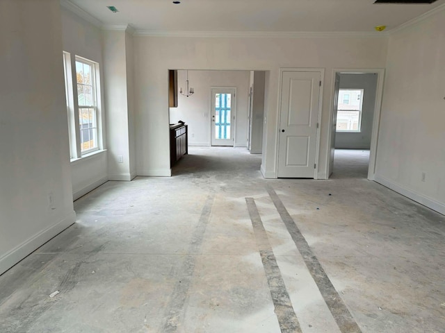 empty room featuring visible vents, baseboards, and crown molding