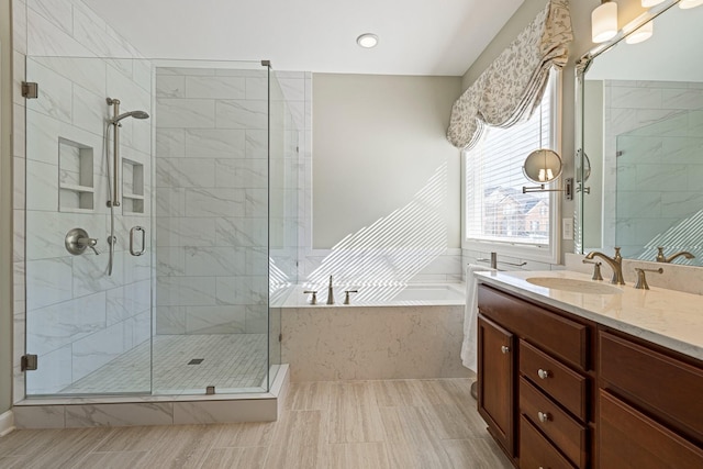 full bath featuring a stall shower, a garden tub, and vanity