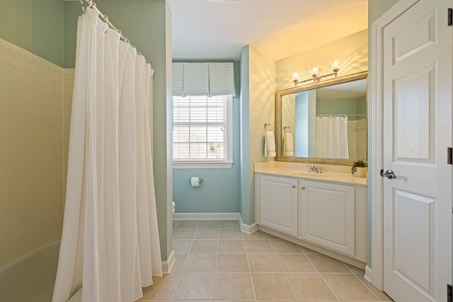 bathroom featuring tile patterned flooring, toilet, vanity, baseboards, and shower / bathtub combination with curtain