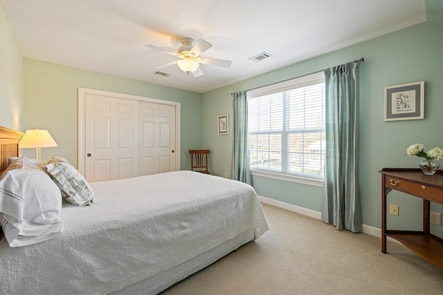 bedroom with baseboards, visible vents, a ceiling fan, and light colored carpet