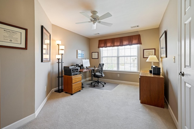 office area with light carpet, baseboards, visible vents, and ceiling fan