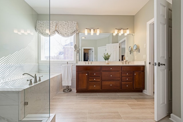 full bathroom with double vanity, a garden tub, an enclosed shower, and a sink