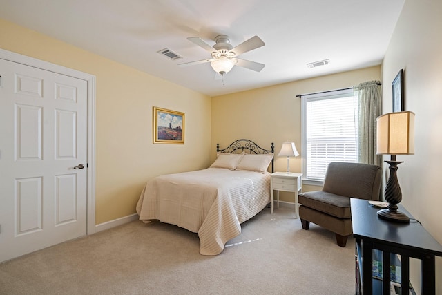 bedroom with baseboards, visible vents, and light colored carpet