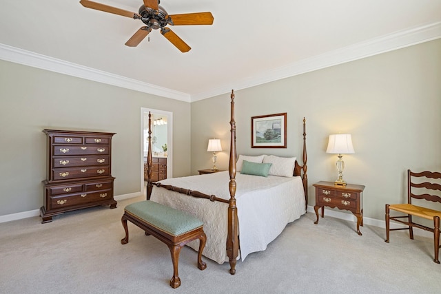 bedroom featuring light colored carpet, crown molding, baseboards, and ensuite bathroom