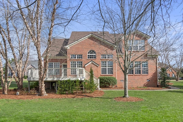 view of front facade with crawl space, brick siding, a wooden deck, and a front lawn