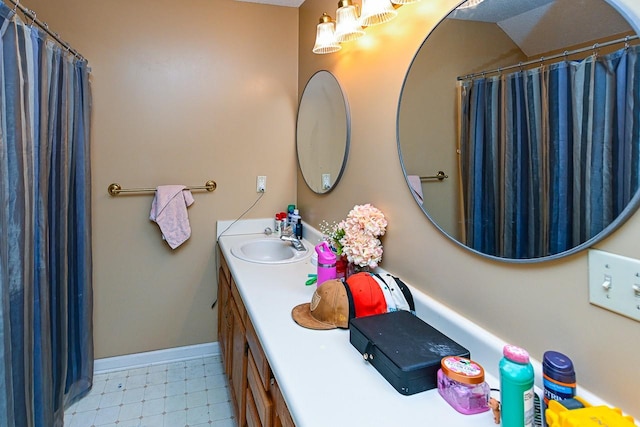 full bathroom with baseboards, curtained shower, vanity, and tile patterned floors