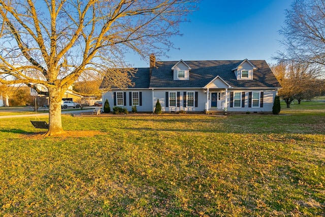 cape cod house with a front lawn