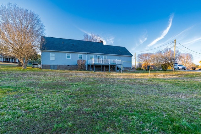 back of house featuring stairs, a deck, and a yard