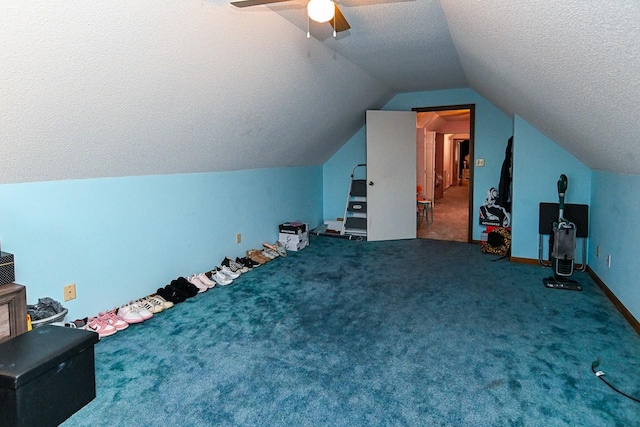 bonus room with baseboards, a ceiling fan, lofted ceiling, a textured ceiling, and carpet floors