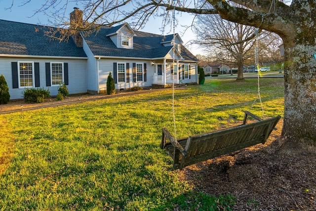 view of front of property with roof with shingles, crawl space, a chimney, and a front yard