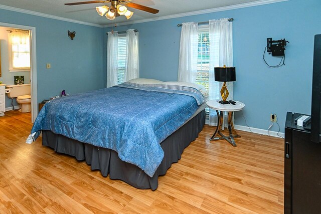 bedroom with ensuite bathroom, wood finished floors, a ceiling fan, baseboards, and ornamental molding