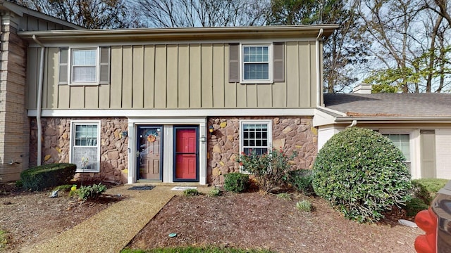 view of front of home with stone siding and board and batten siding