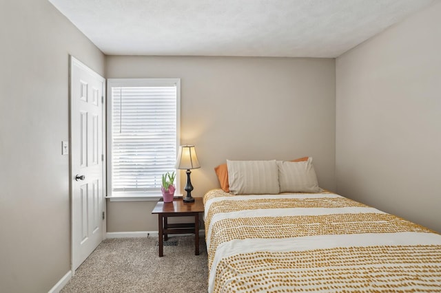 carpeted bedroom featuring baseboards