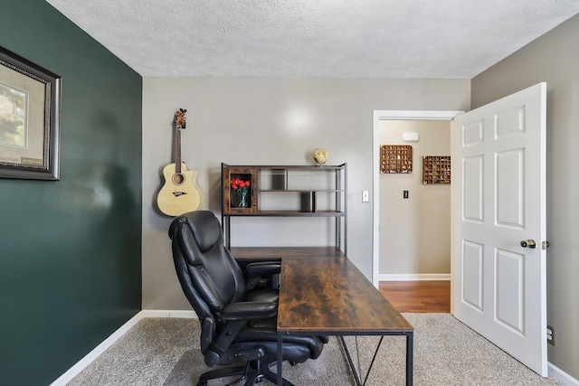 office with baseboards and a textured ceiling