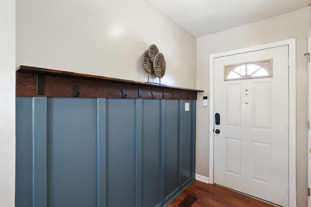 foyer featuring dark wood-style floors and visible vents