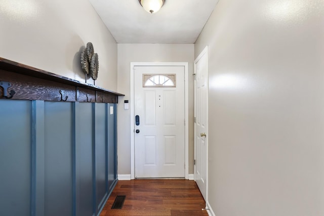 entryway featuring baseboards, visible vents, and dark wood-style flooring