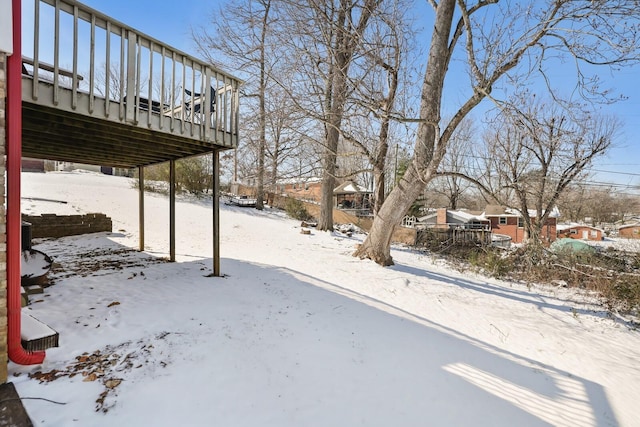 yard layered in snow featuring a deck