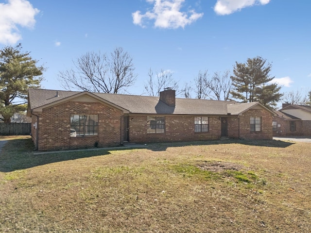 ranch-style house with a chimney, a front lawn, and brick siding