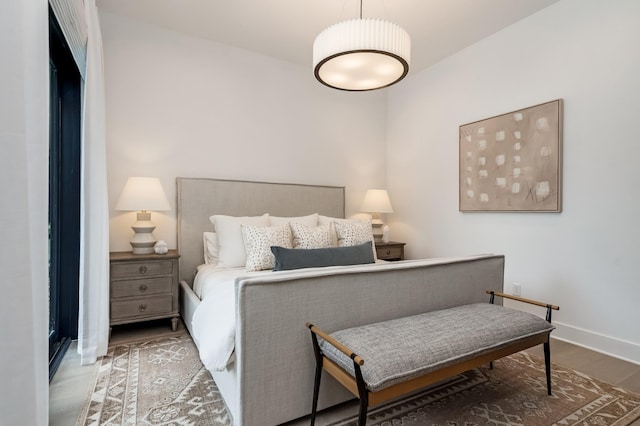 bedroom featuring wood finished floors and baseboards