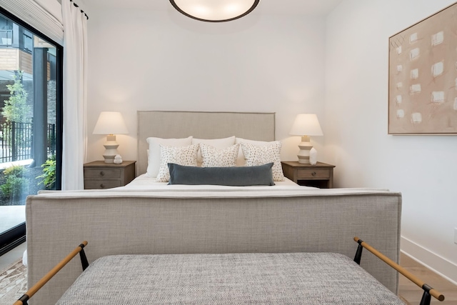 bedroom featuring baseboards and wood finished floors