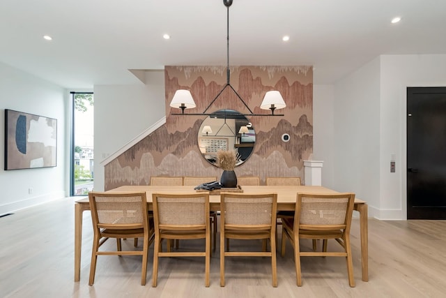 dining area featuring a wall of windows, recessed lighting, baseboards, and light wood finished floors