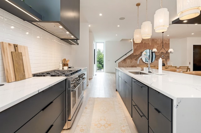 kitchen featuring tasteful backsplash, modern cabinets, a sink, and double oven range