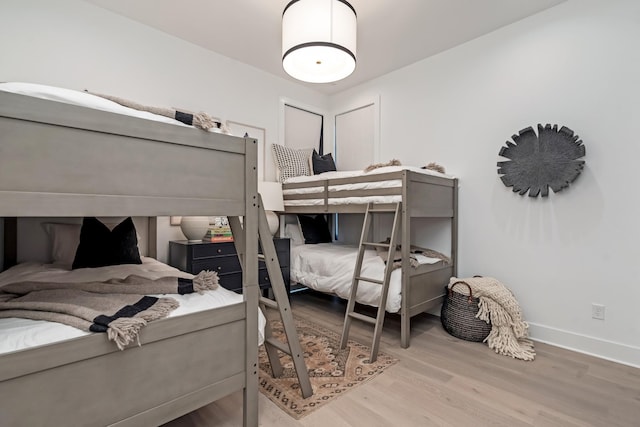 bedroom featuring baseboards and wood finished floors