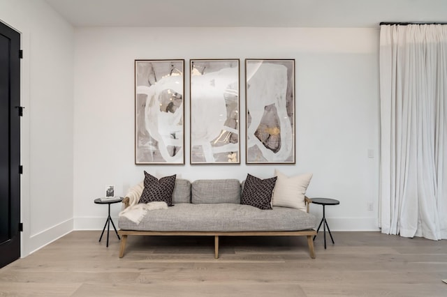 living area featuring wood finished floors and baseboards