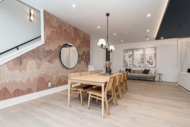 dining space featuring recessed lighting, an accent wall, baseboards, light wood-style floors, and wallpapered walls