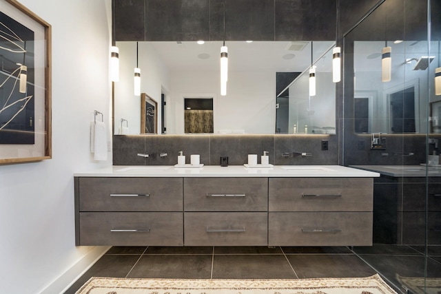 full bathroom with a sink, double vanity, tile patterned flooring, and decorative backsplash