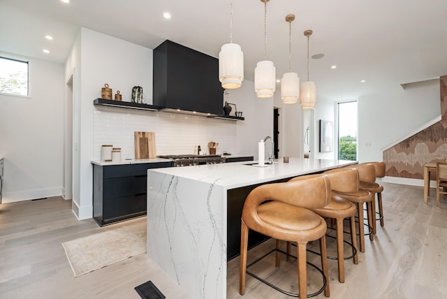 bar featuring light wood-style flooring, recessed lighting, plenty of natural light, and backsplash