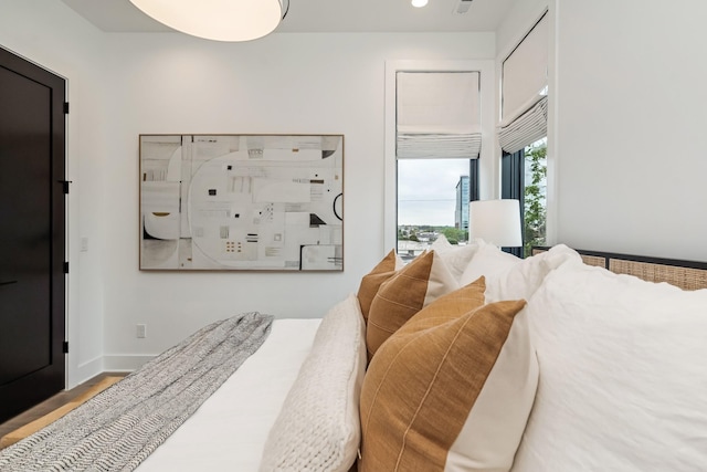 bedroom featuring baseboards and wood finished floors