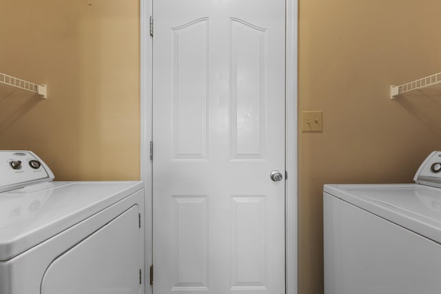 washroom featuring independent washer and dryer and laundry area