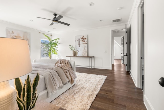 bedroom with dark wood finished floors, crown molding, visible vents, ceiling fan, and baseboards