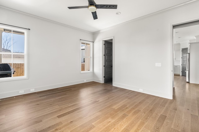 unfurnished bedroom with visible vents, light wood-style flooring, ornamental molding, a ceiling fan, and baseboards