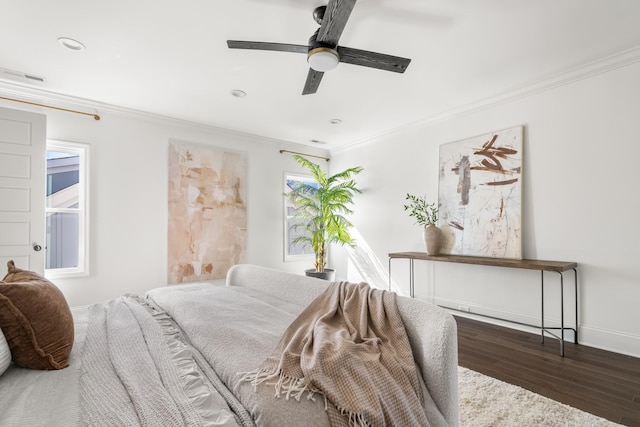 bedroom featuring visible vents, ornamental molding, and wood finished floors