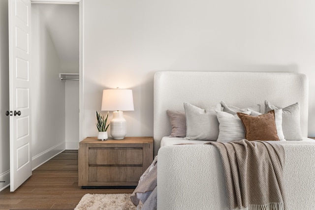 bedroom with baseboards and wood finished floors